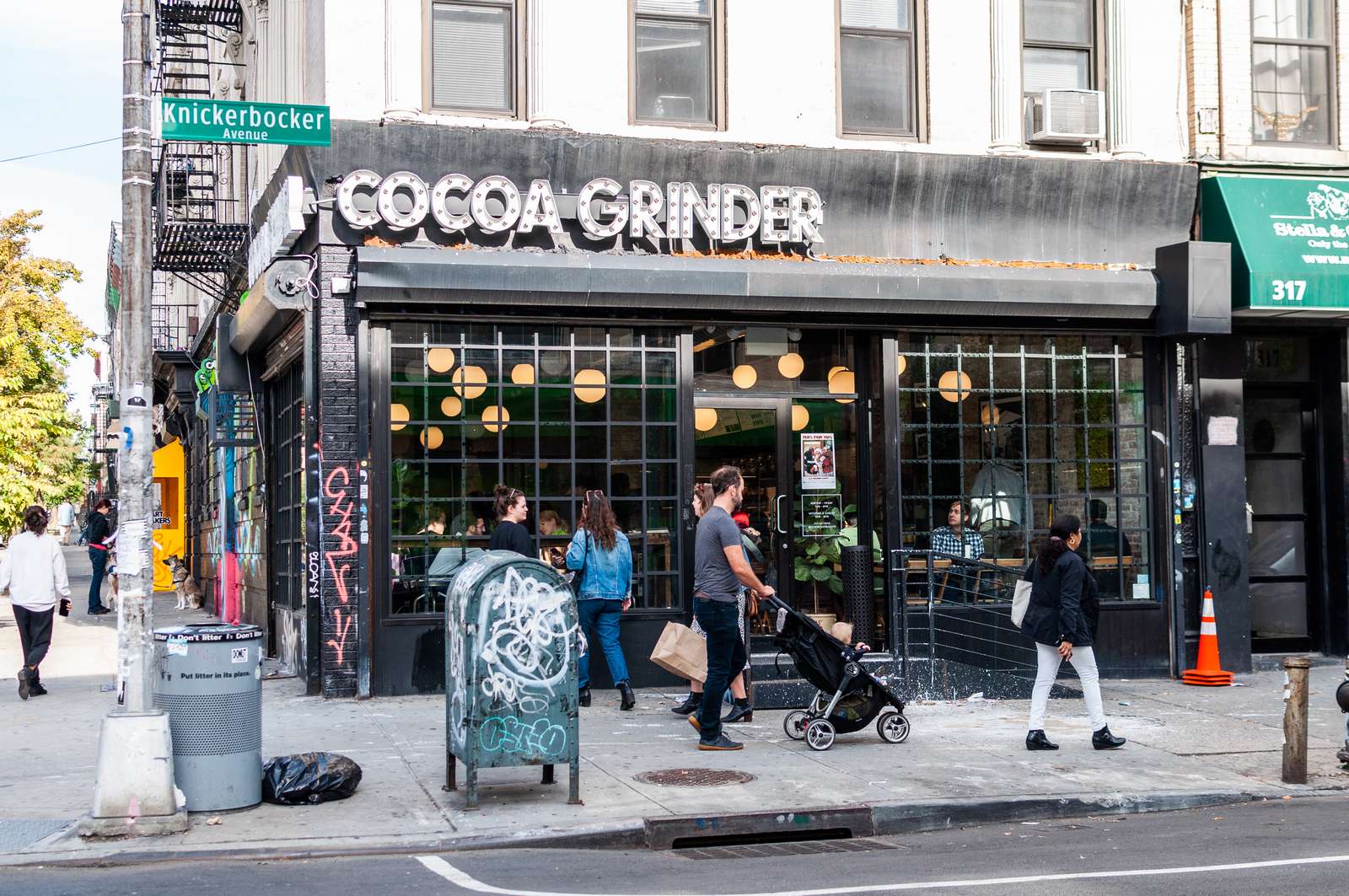 Cocoa Grinder exterior with people walking