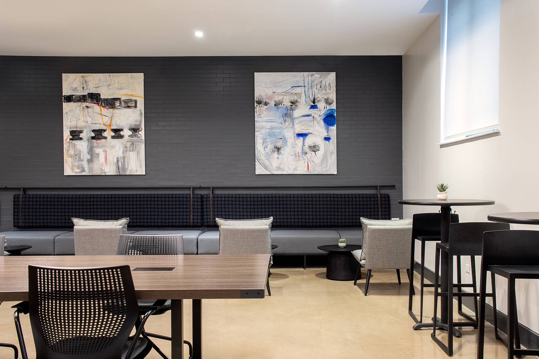 Detail shot of coworking space with large modern artwork on walls and seating throughout